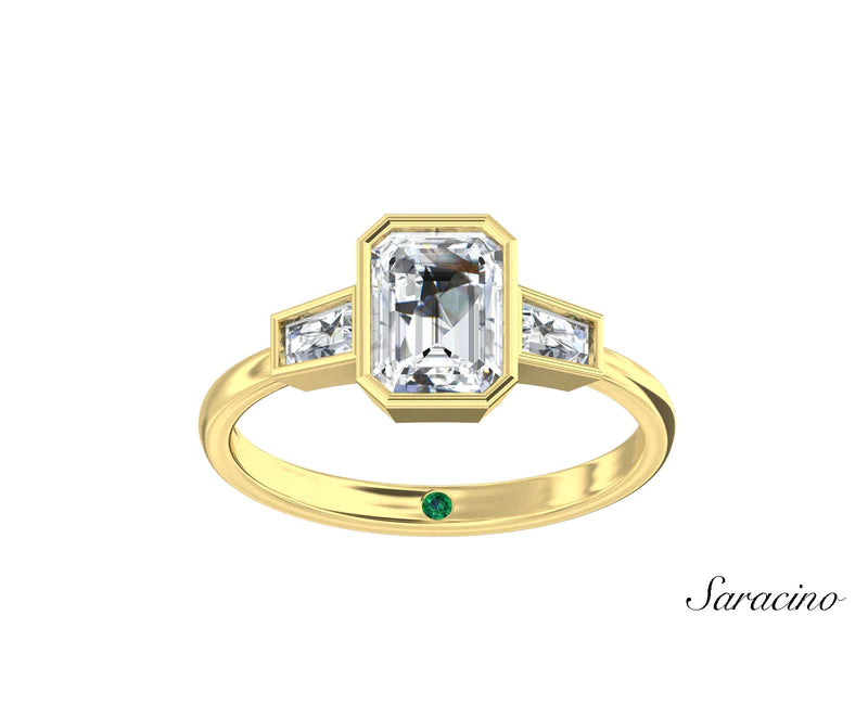 A unique emerald cut engagement ring with tapered baguette side diamonds